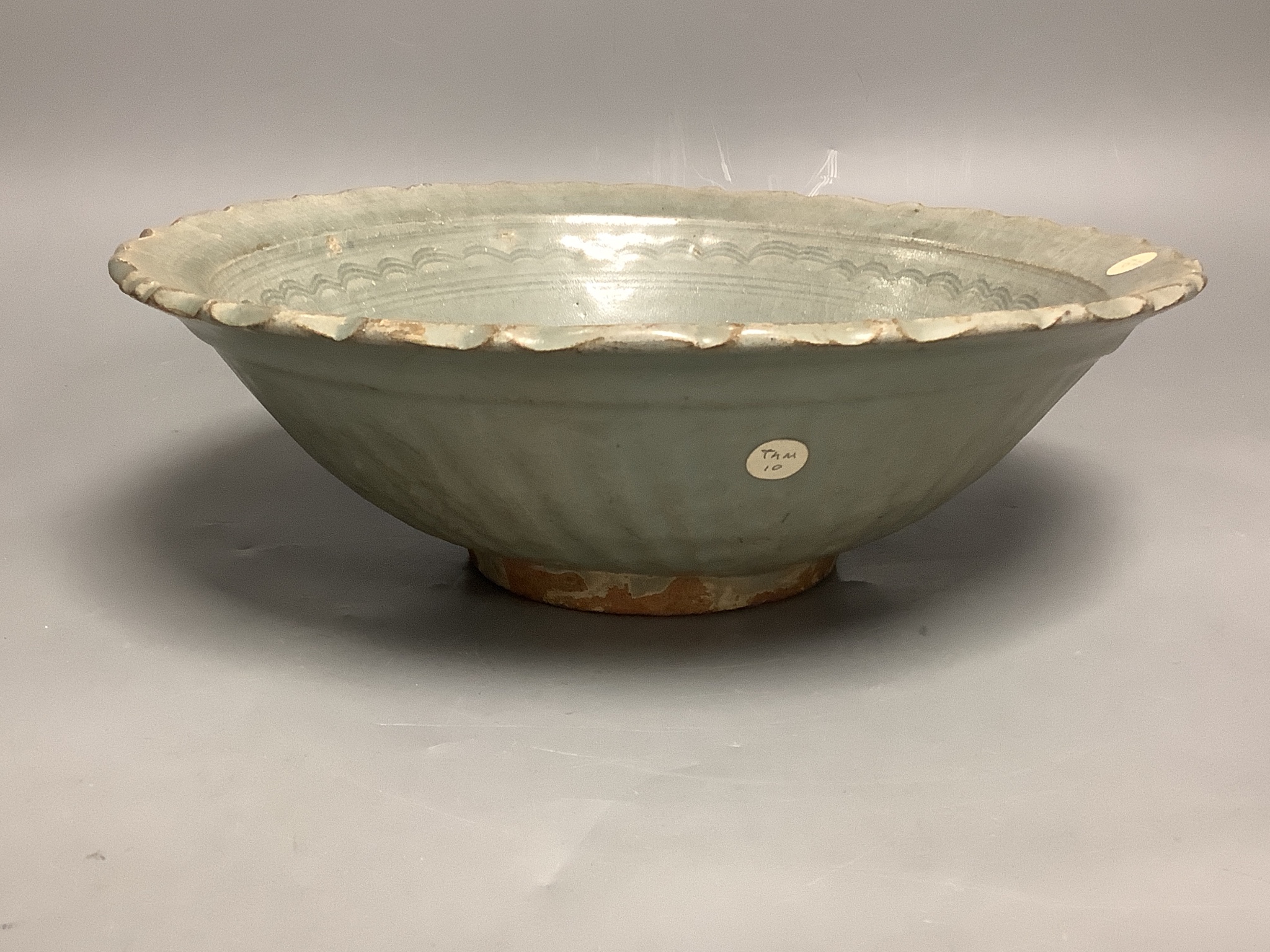 A Thai Sawankhalok celadon bowl, 14th-16th century, 28cms diameter